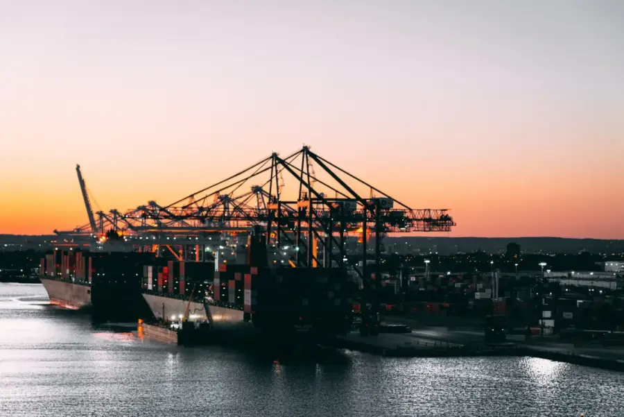 Cargo cranes at a container port at dusk